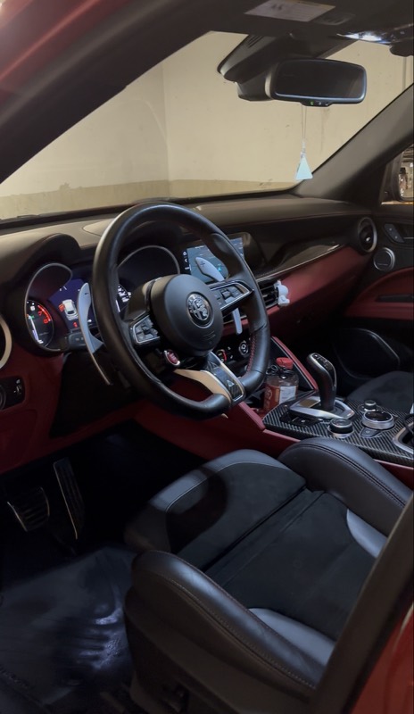 Alfa Romeo Stelvio cockpit with red trim after detailing