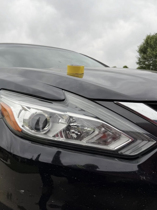 Restored headlight on a black Nissan