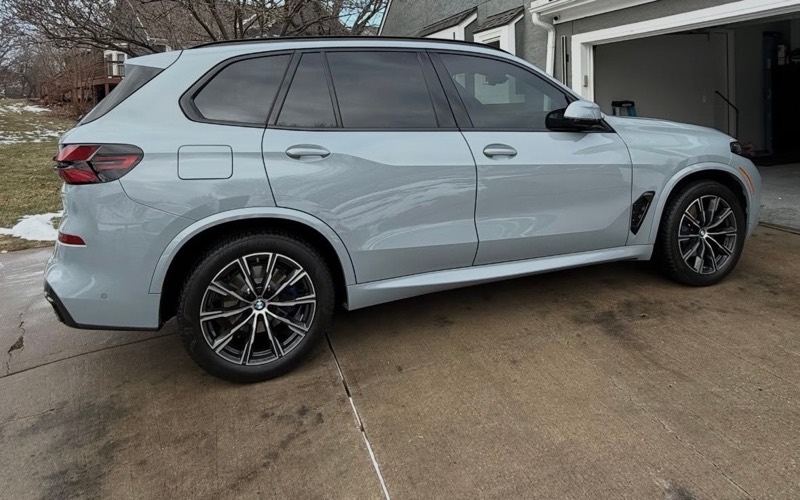 White BMW X5 in a driveway after an exterior detail