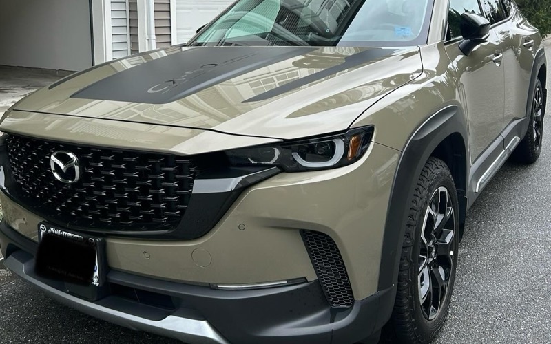 Mazda CX-50 parked outside a townhouse after a mobile detail