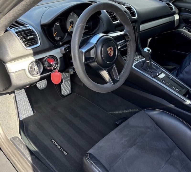Clean Porsche cockpit with suede wheel after a mini interior detail