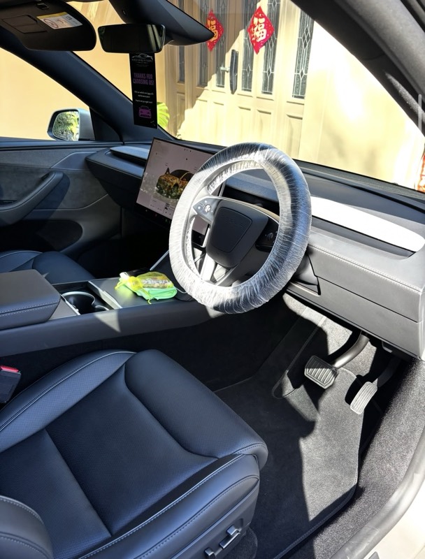 Tesla interior with steering wheel cover after a detail