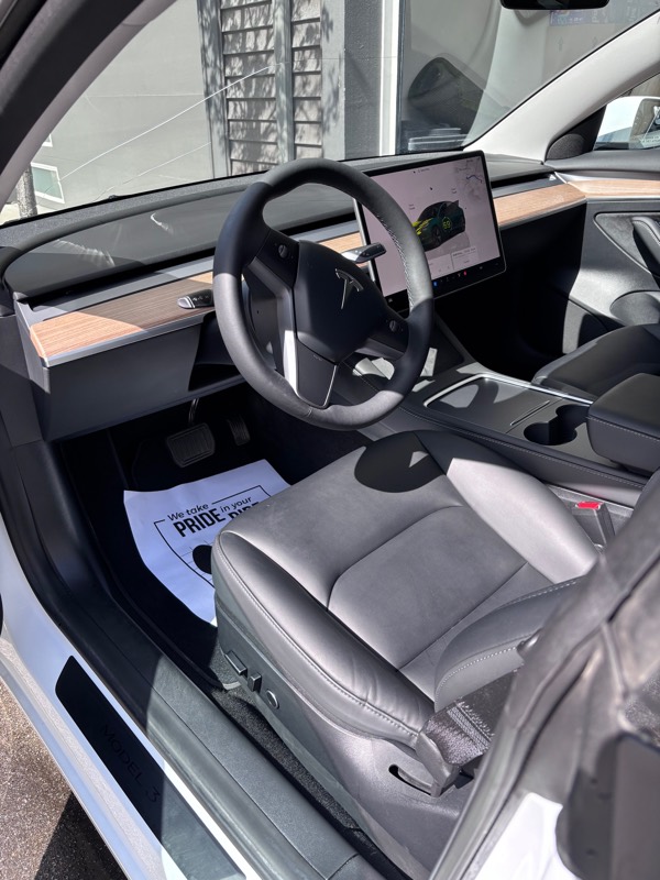 Tesla interior with white seats after detailing